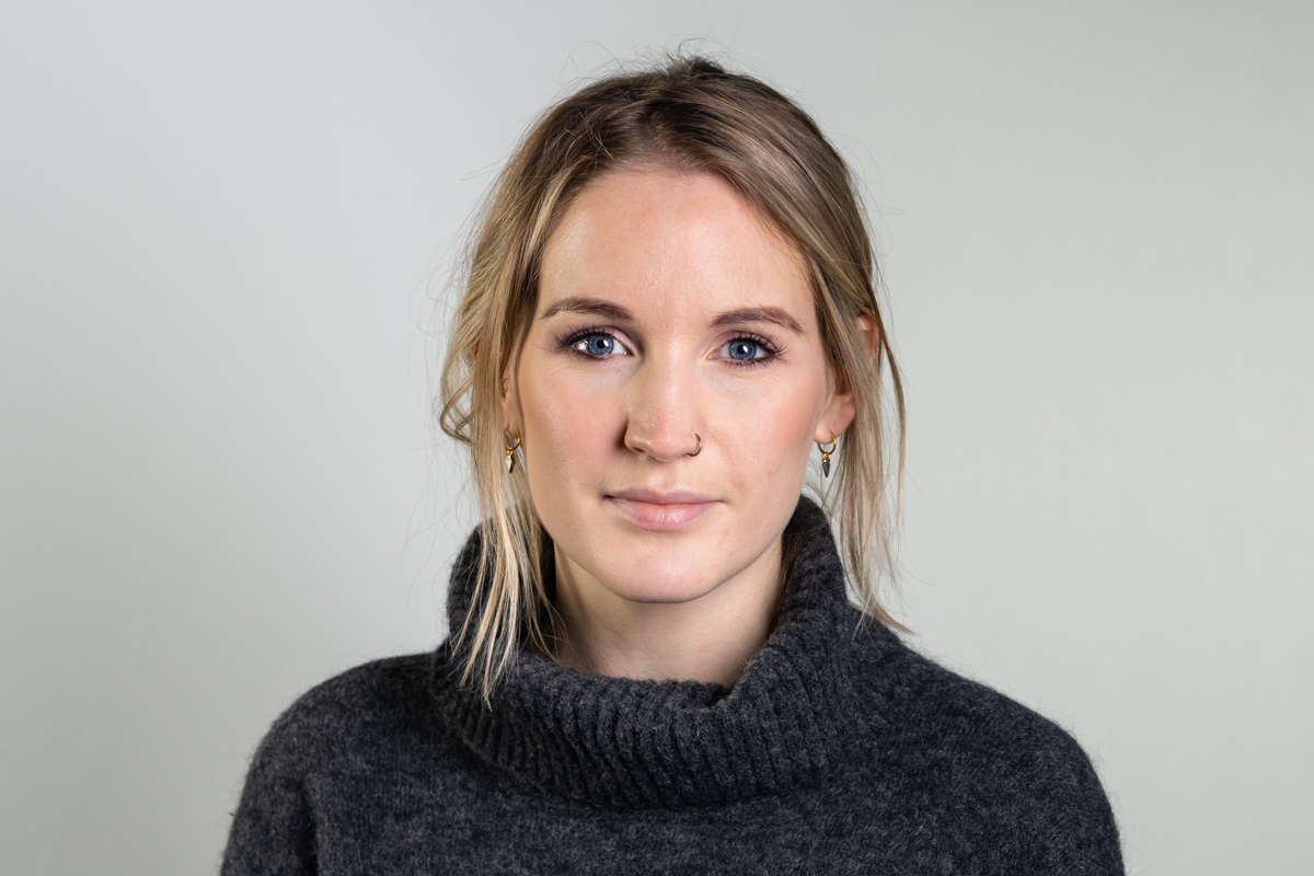 a woman with blonde hair wearing a sweater